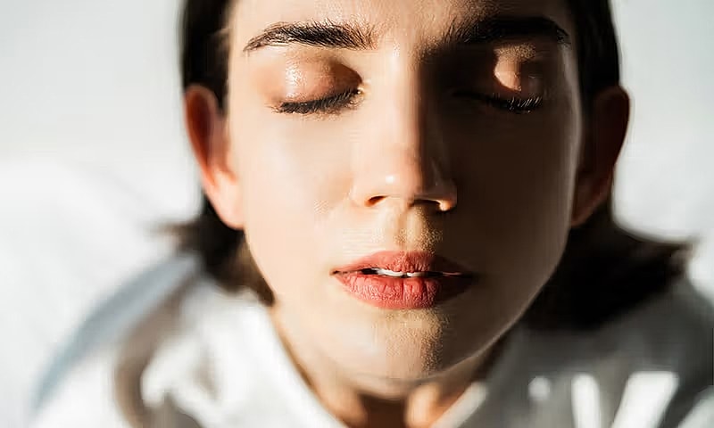 Close-up of a peaceful woman's serene face.