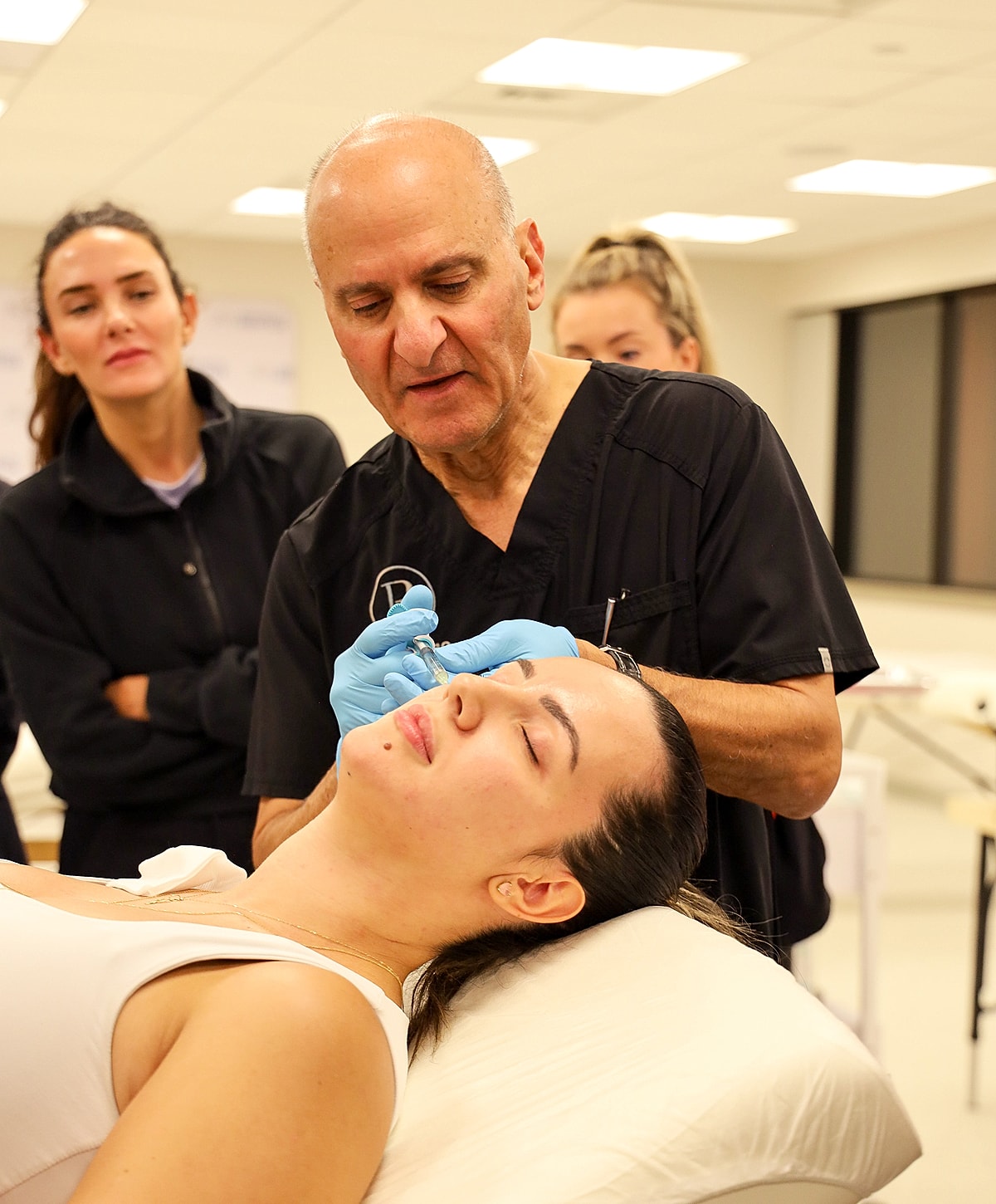 Medical professionals treating a patient's leg.
