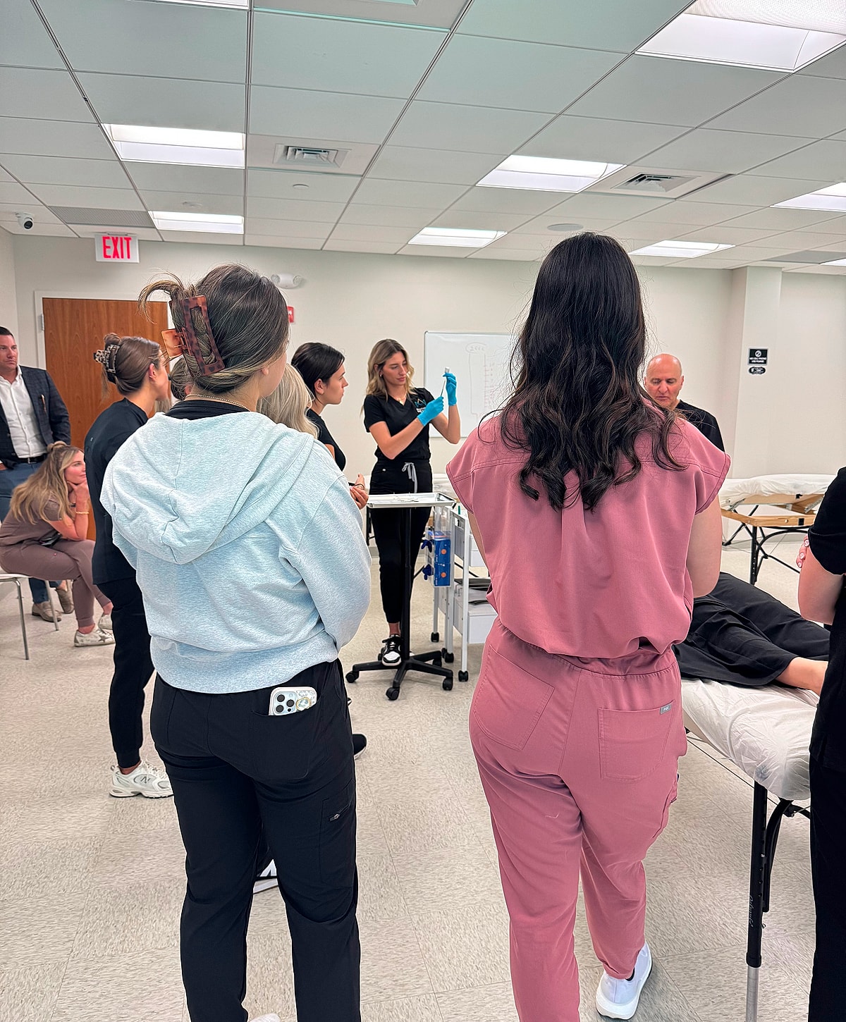 Medical training session with students observing a demonstration.
