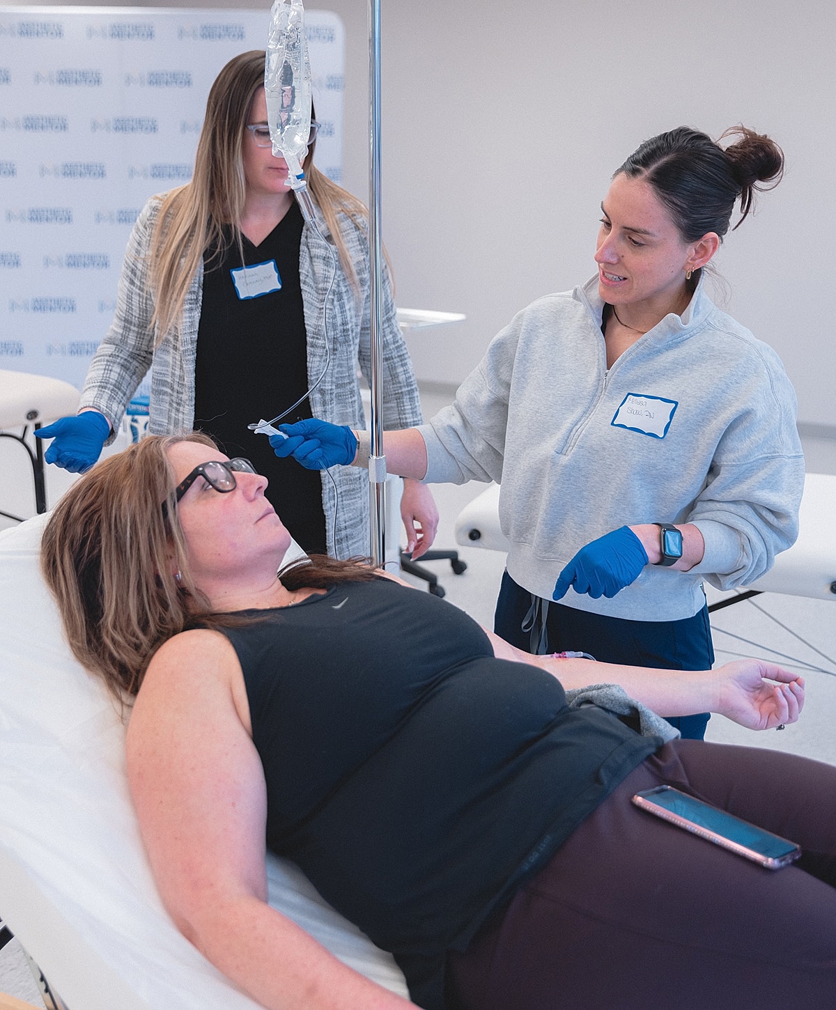 Healthcare professionals administering IV treatment session.