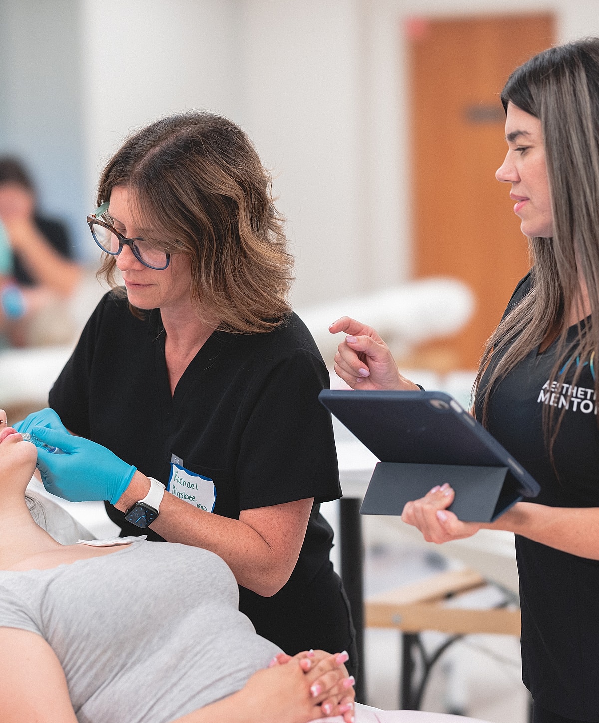 Aesthetic procedure with professionals and client interaction.