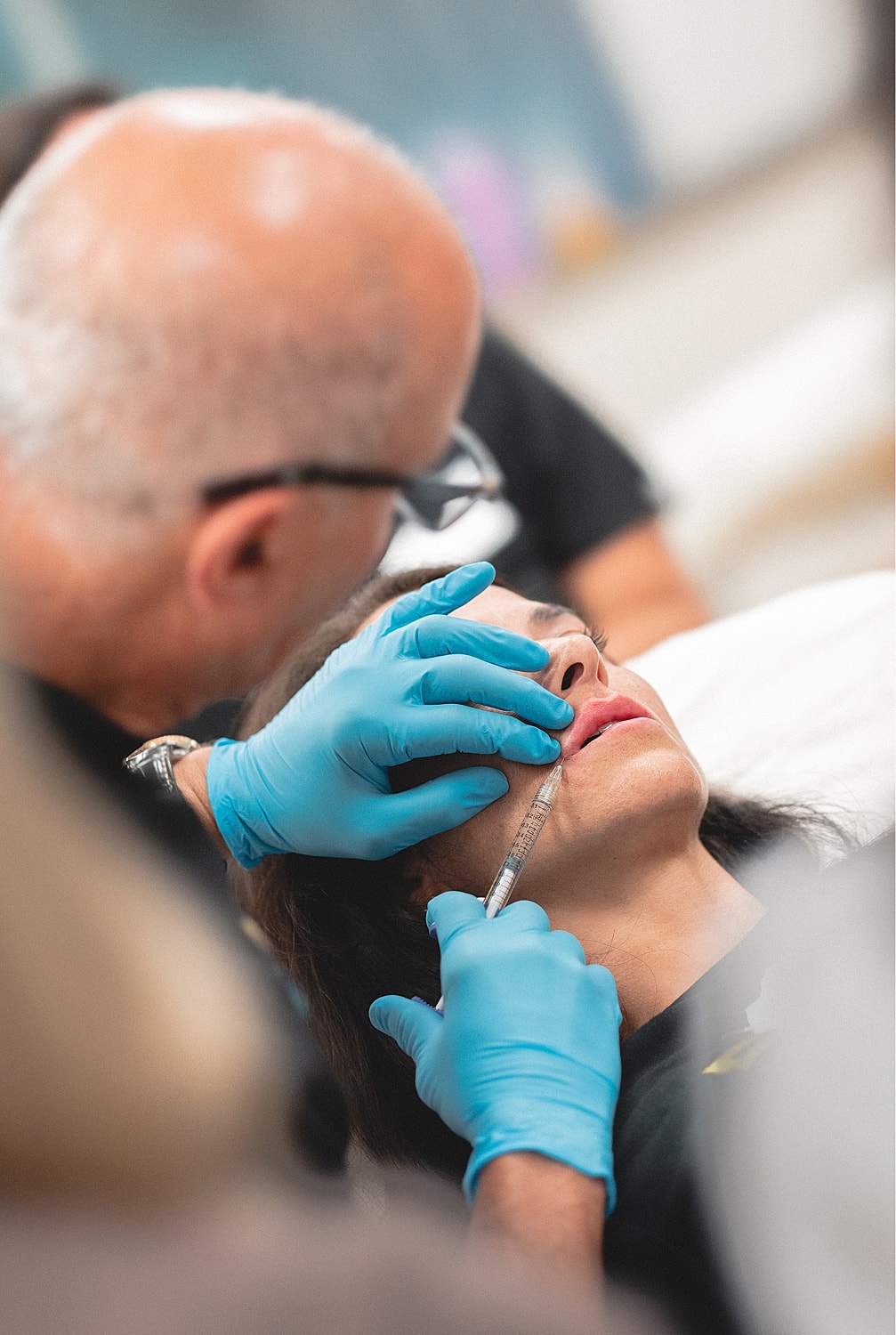 Doctor performing a procedure with attentive audience.