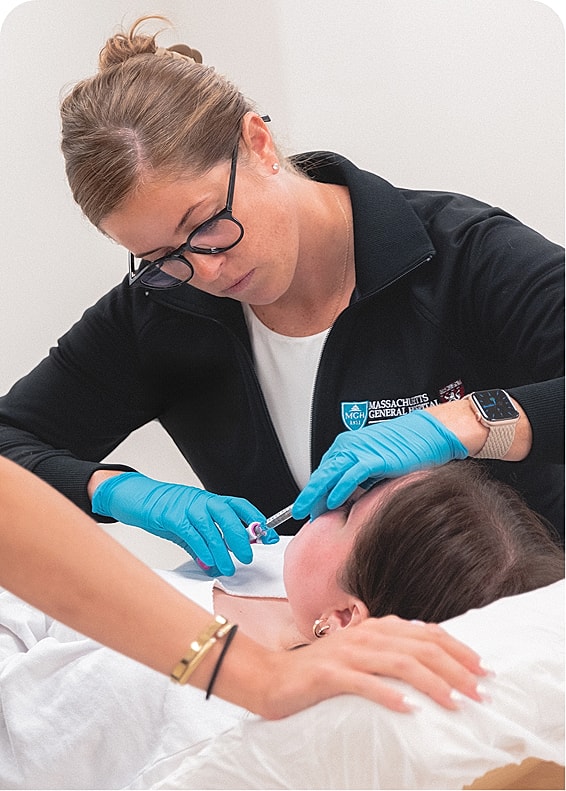 Medical professional administering treatment to patient.