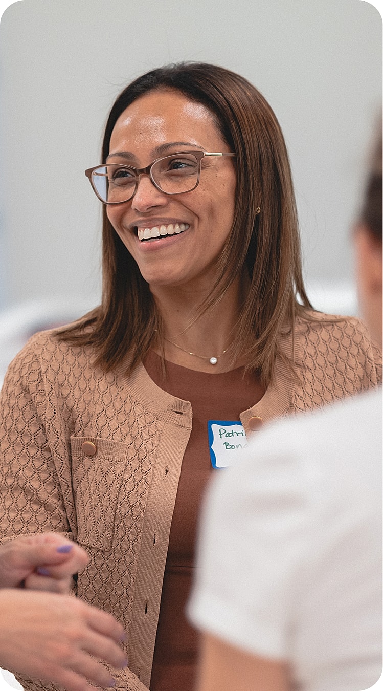 Smiling woman in a casual group discussion.