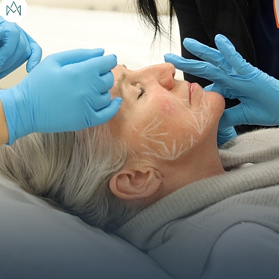 Facial treatment being administered to a patient.