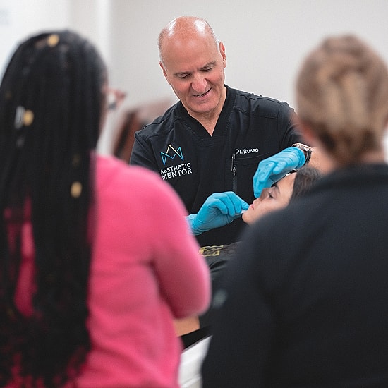 Medical demonstration with students observing and learning.
