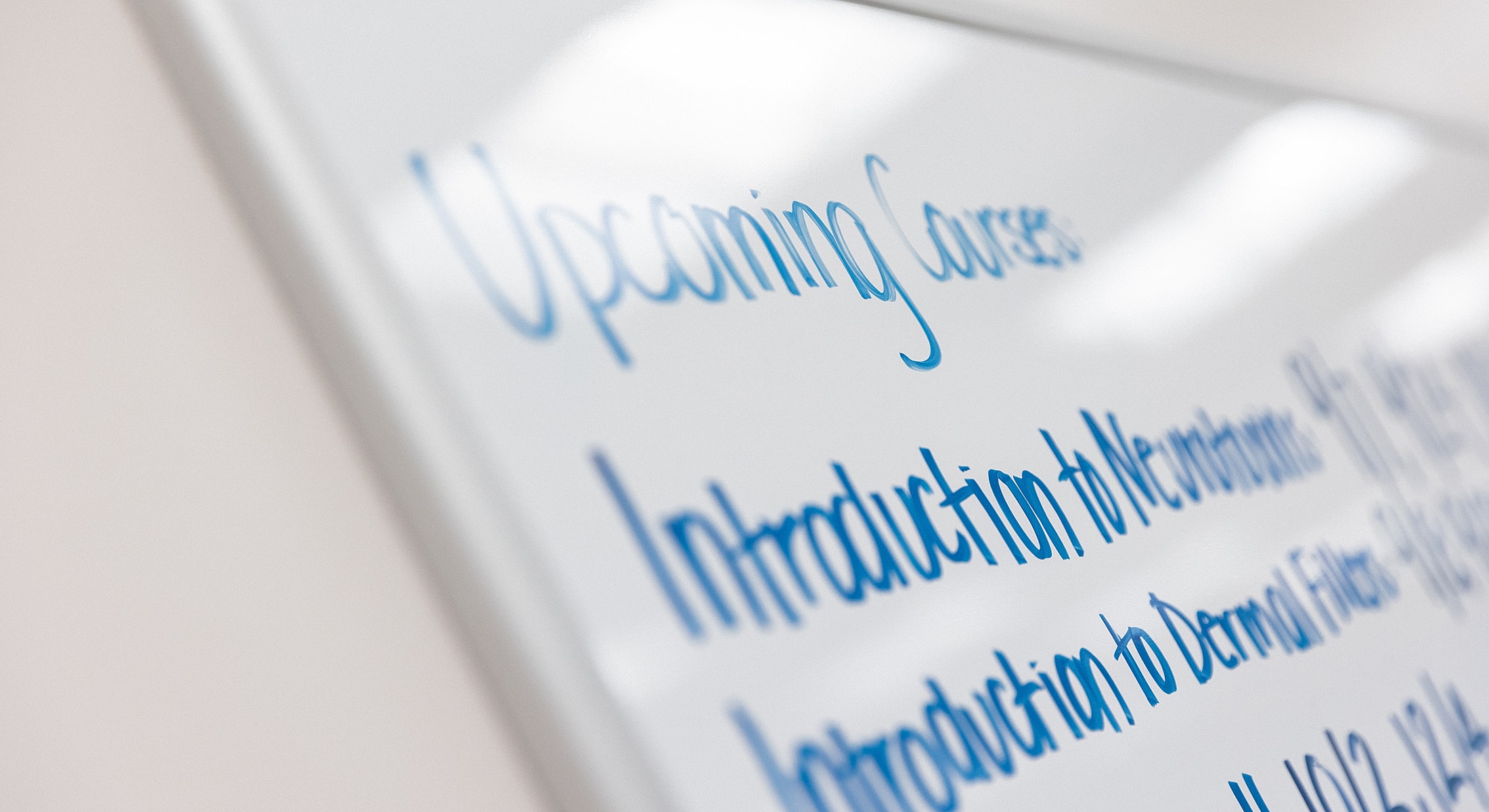 Whiteboard with upcoming course list and dates