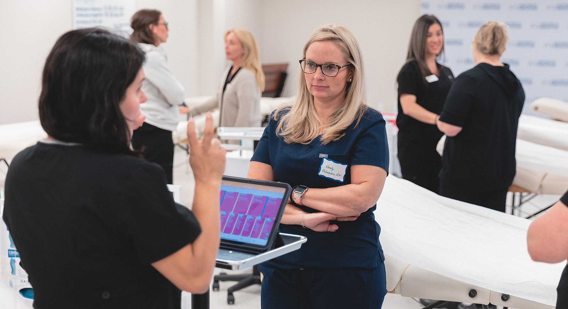 Medical professionals engaged in training session.