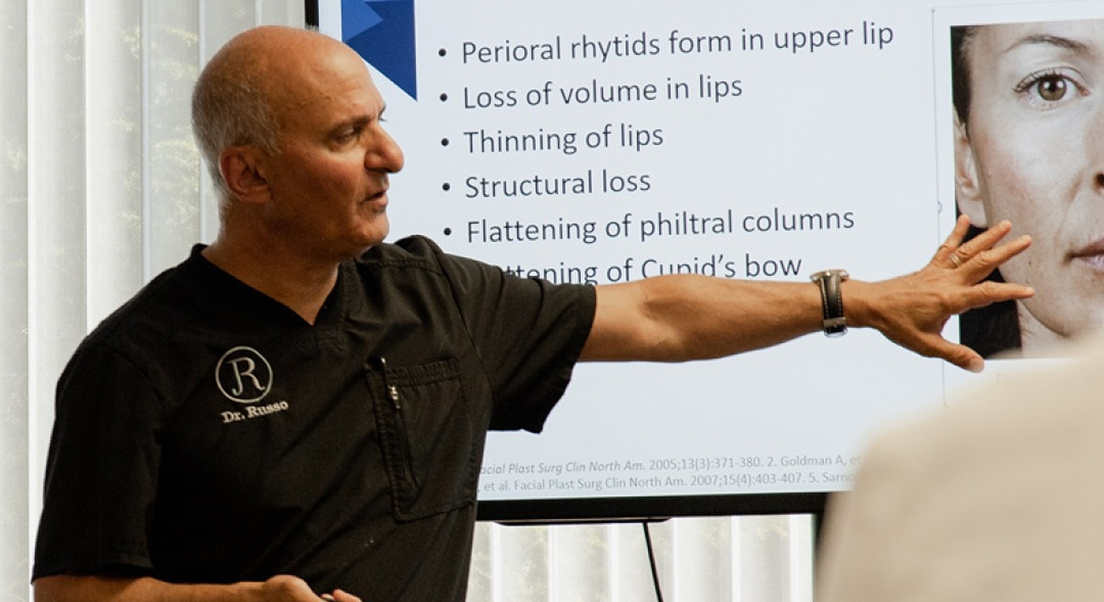 Doctor presenting about lip structure and loss.