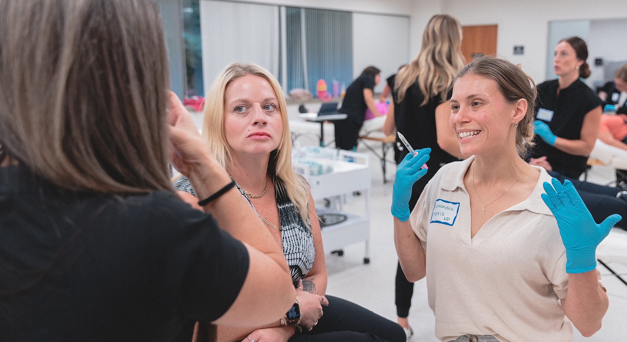 Two women discussing aesthetic procedures in training.