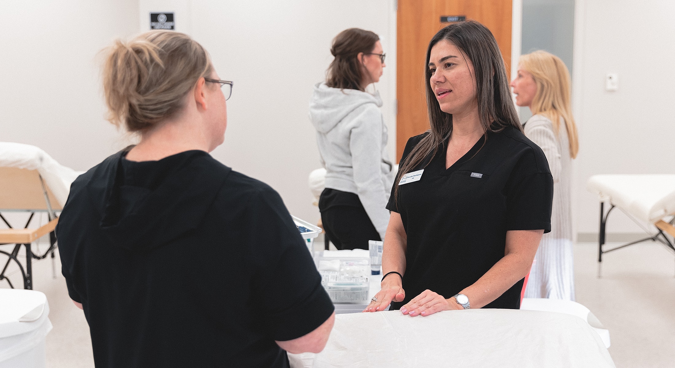 Healthcare professionals discussing patient care techniques.