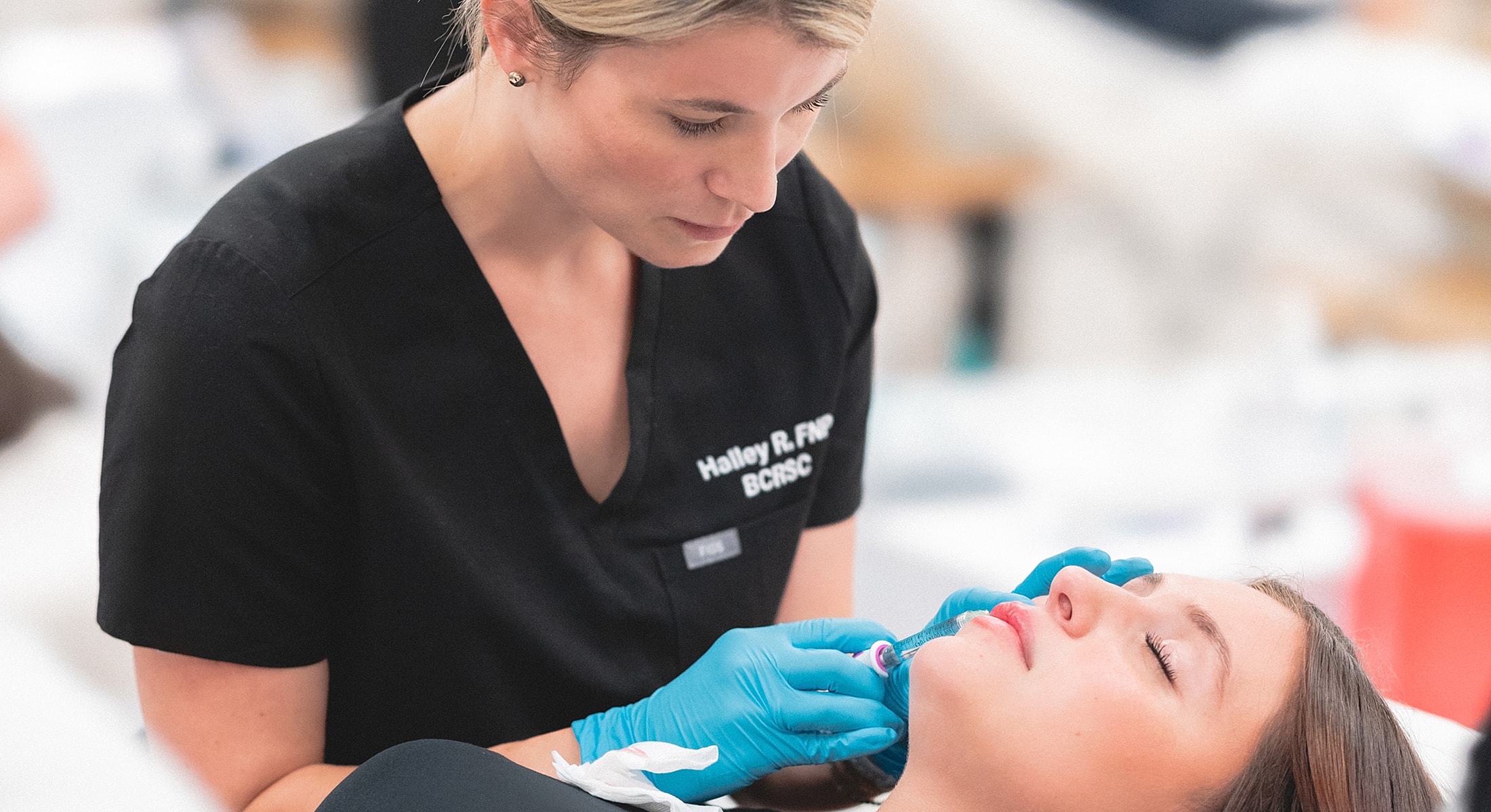 Medical professional administering treatment to patient.