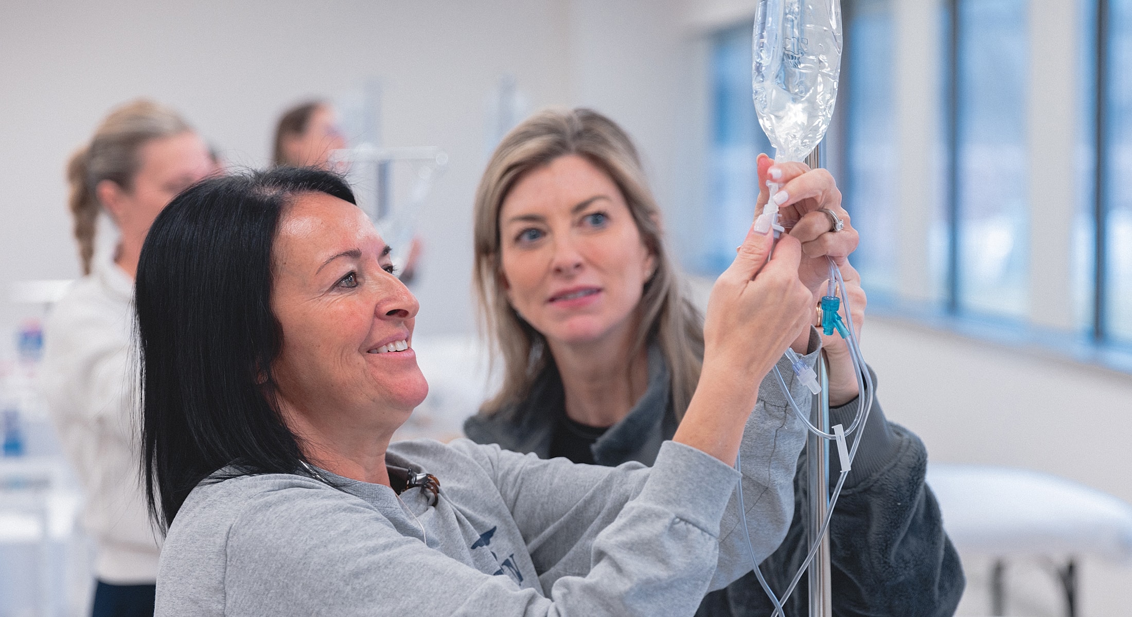 Nurses practicing IV preparation techniques in training.