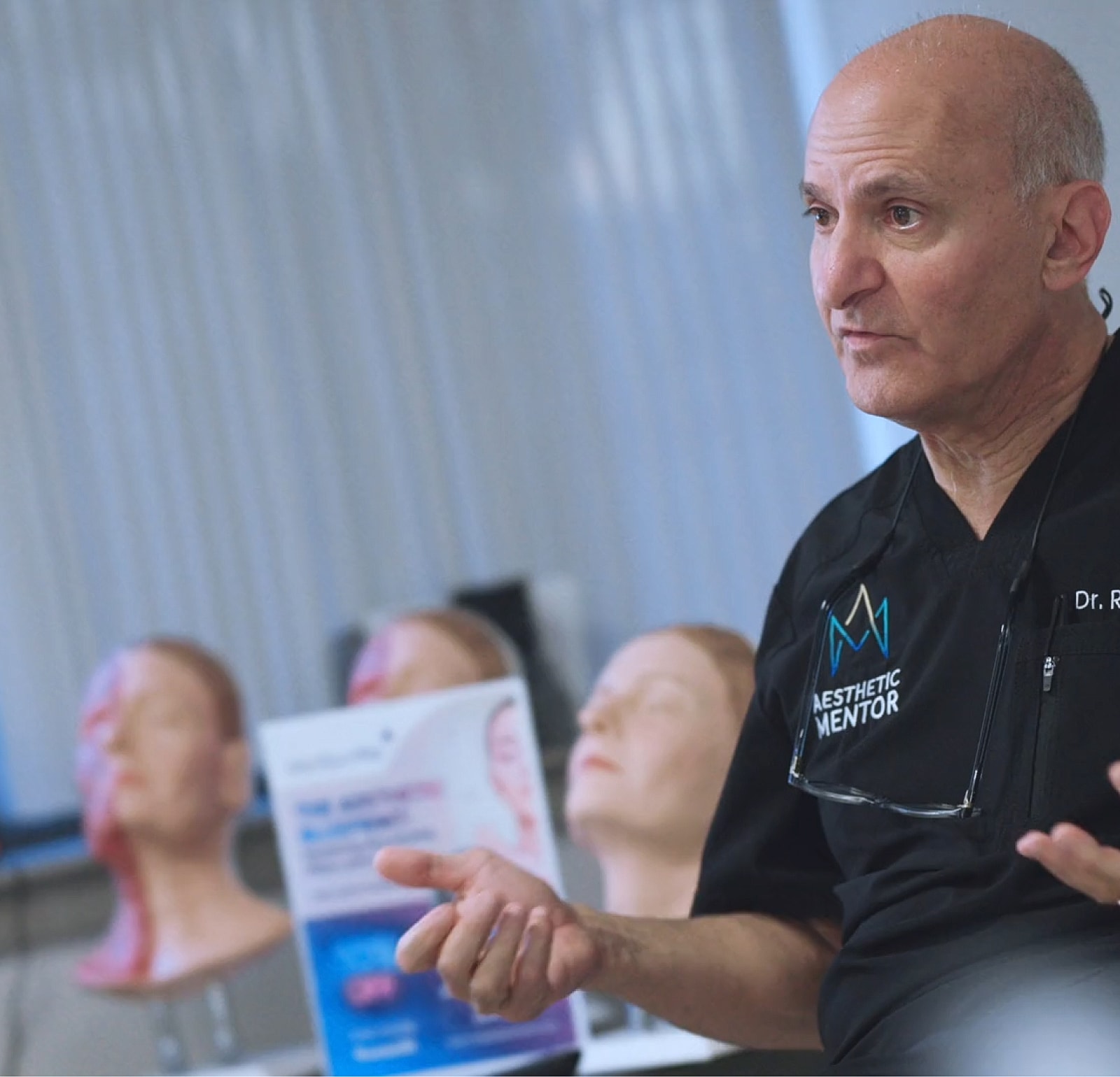 Instructor demonstrating aesthetic procedures to trainees.