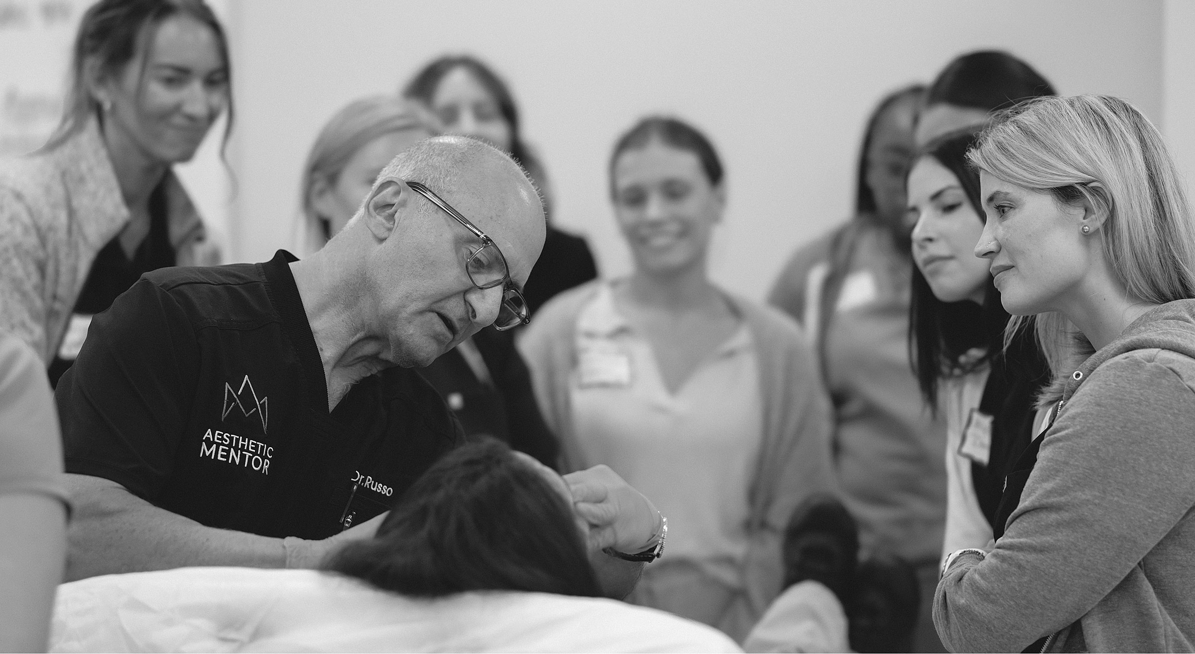 Instructor demonstrating a procedure to attentive students.
